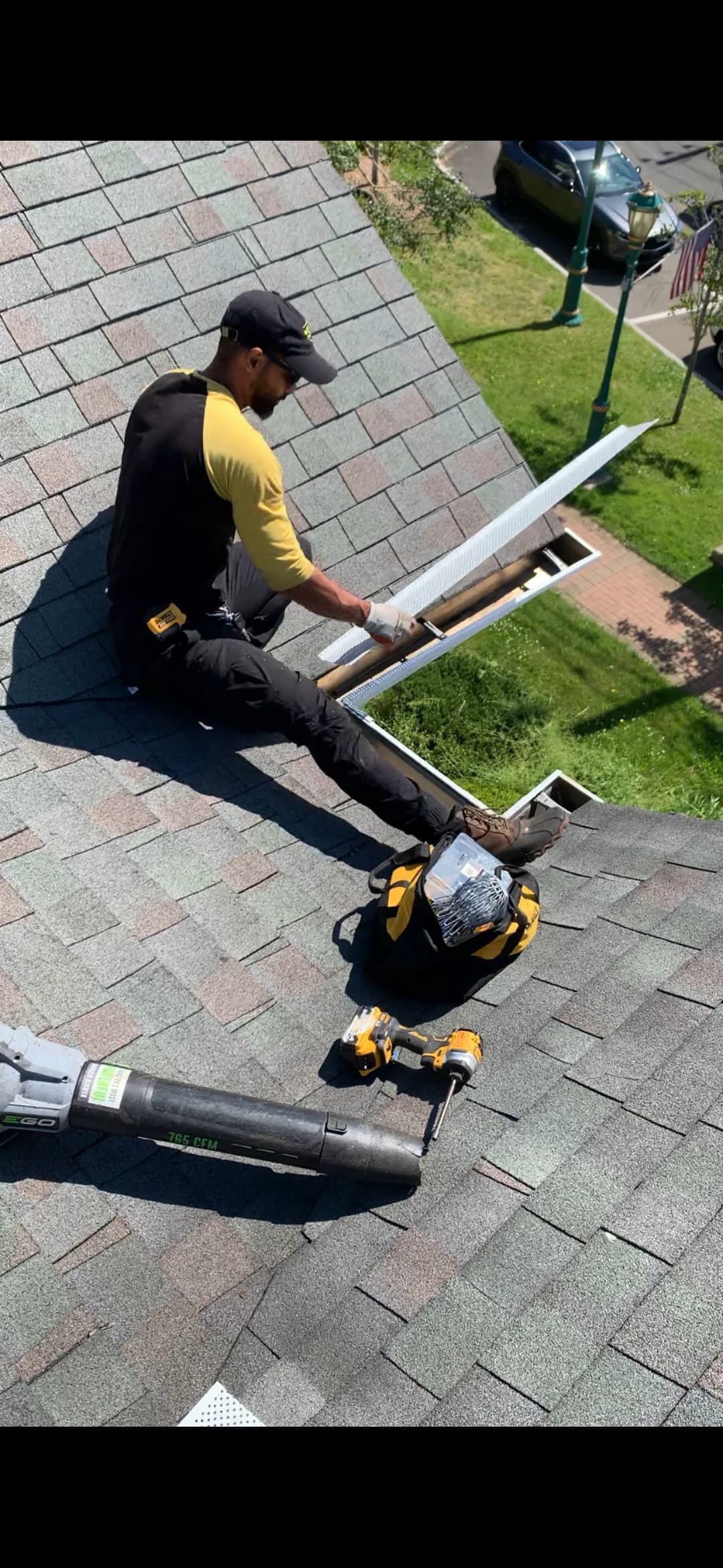 We Gutter technician installing micro-mesh gutter guard on a roof in Connecticut — gutter guard installation in Glastonbury CT