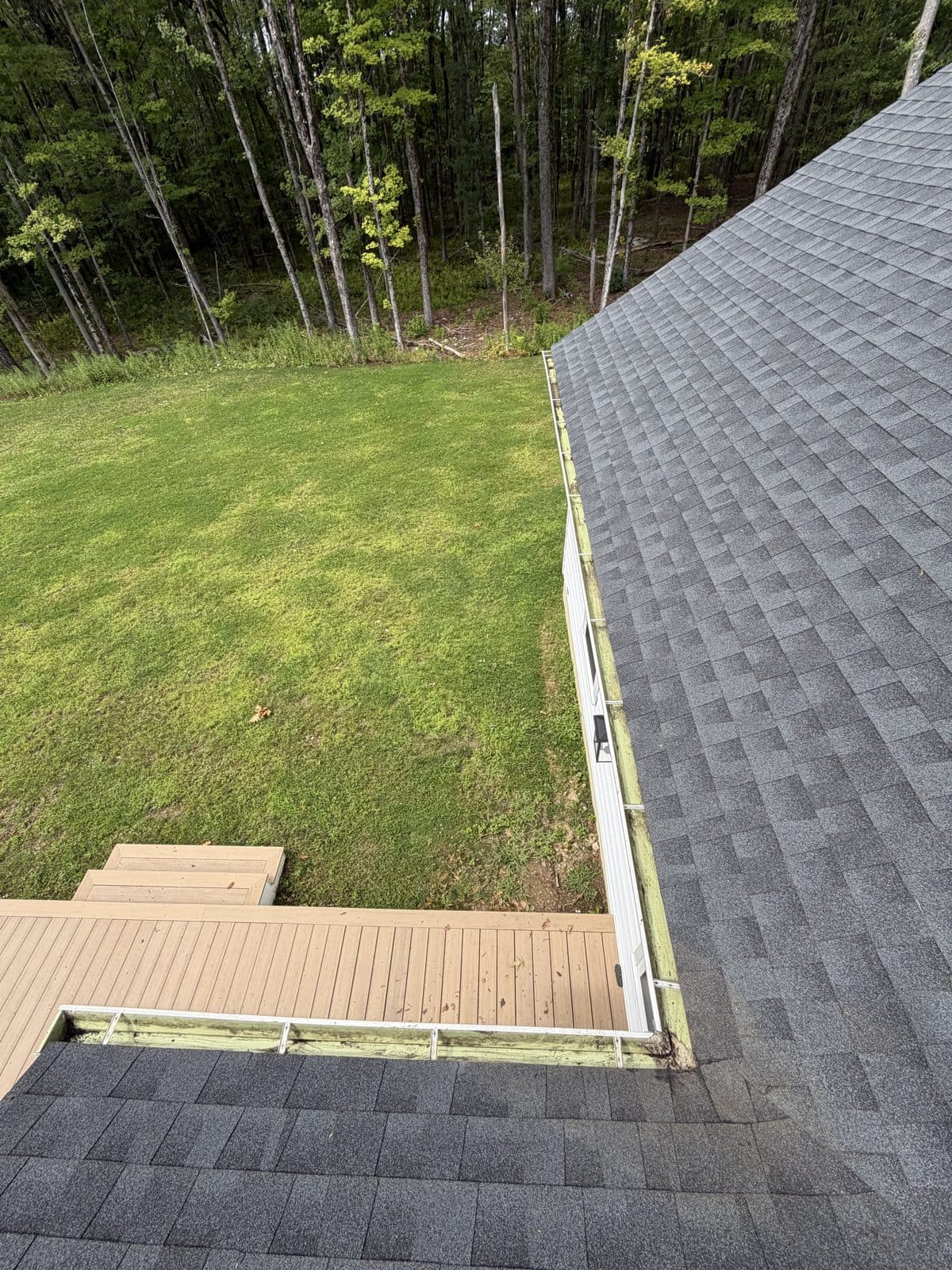Roof-valley gutter corner in Harwinton, Connecticut, after visible leaf debris was removed.