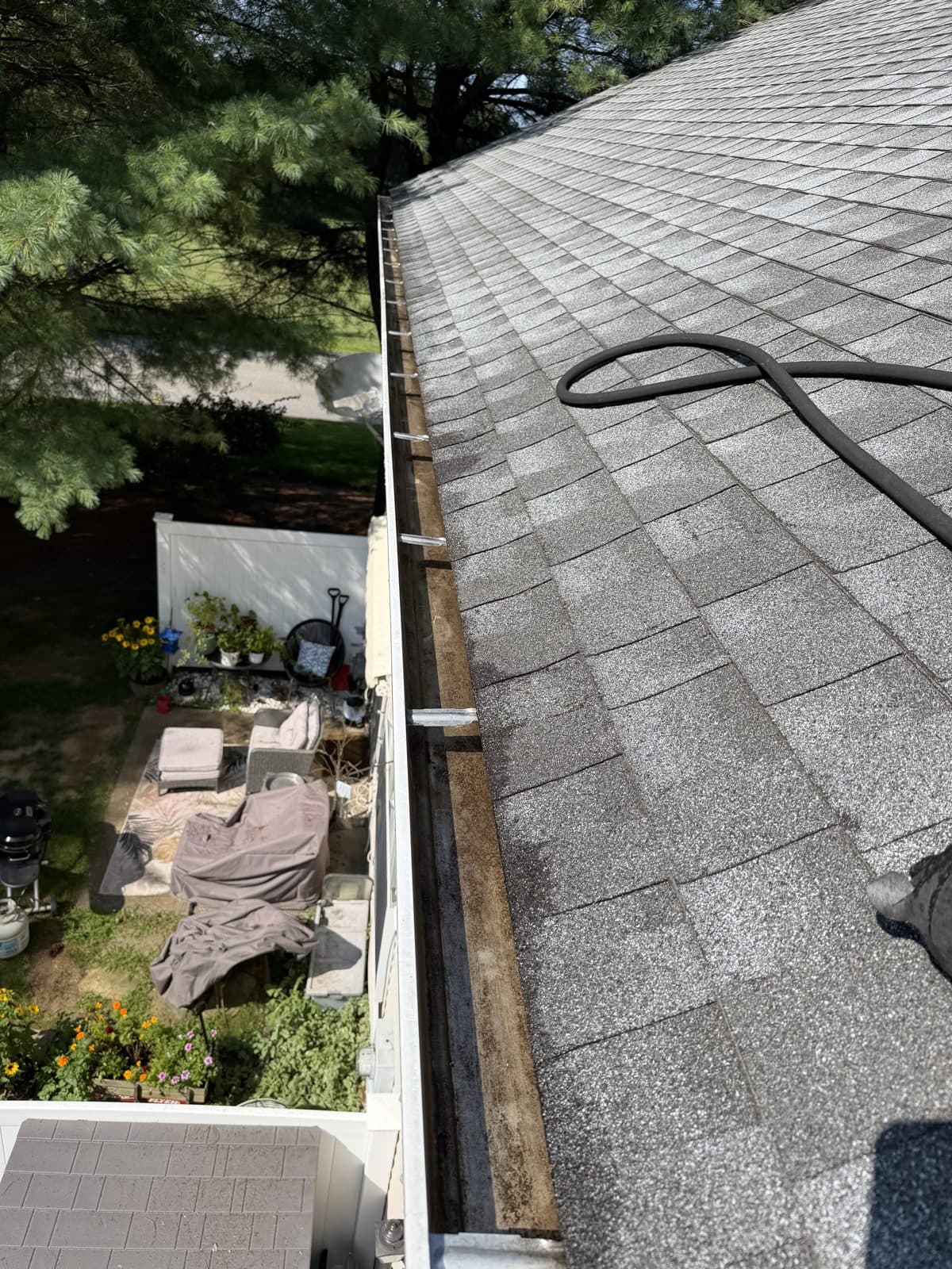 The same Torrington patio-side gutter after accumulated pine needles were removed.